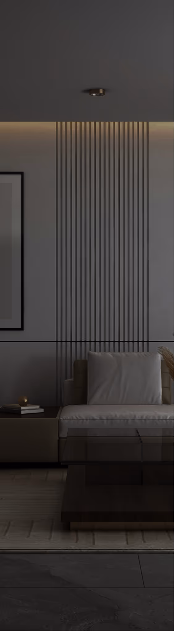 Modern living room with a beige sofa, vertical wood panel accent wall, a glass coffee table, and a side table with books and a small lamp.